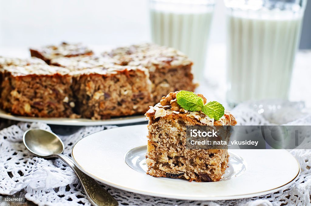 oatmeal cake with dates and walnuts oatmeal cake with dates and walnuts on a light background. tinting. selective focus on mint Cake Stock Photo