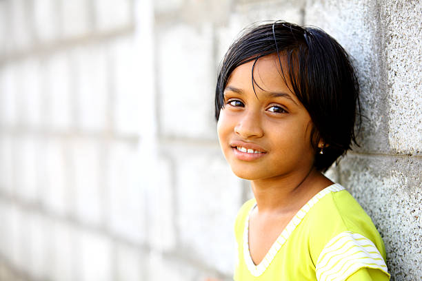 Beautiful Indian girl posing on wall with cute smile
