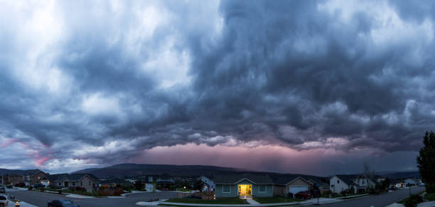 istock Storm Clouds Over Residential Street at Sunset 522619936