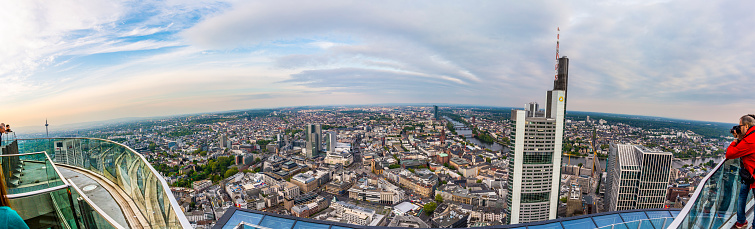 Frankfurt, Germany - May 2, 2015: people enjoy the panorama of Frankfurt am Main with skyscrapers at Maintower. The Maintower platform is free for public.