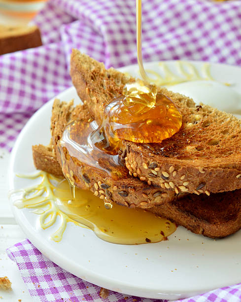 istock Honey poured on toast - breakfast 522622862