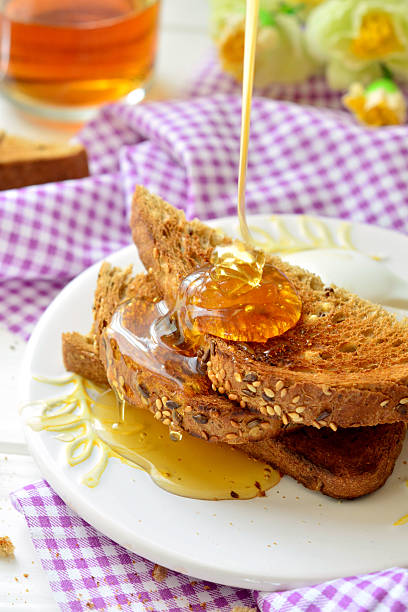 istock Honey poured on toast - breakfast 522622982
