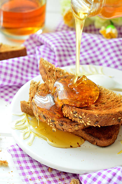 istock Honey poured on toast - breakfast 522623008