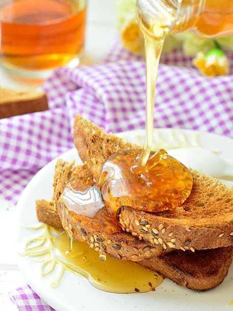 istock Honey poured on toast - breakfast 522623068
