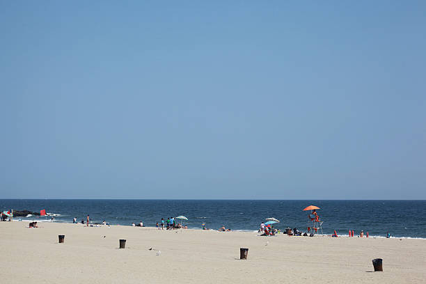 istock Diverse group of people relax by the beach. 522623097