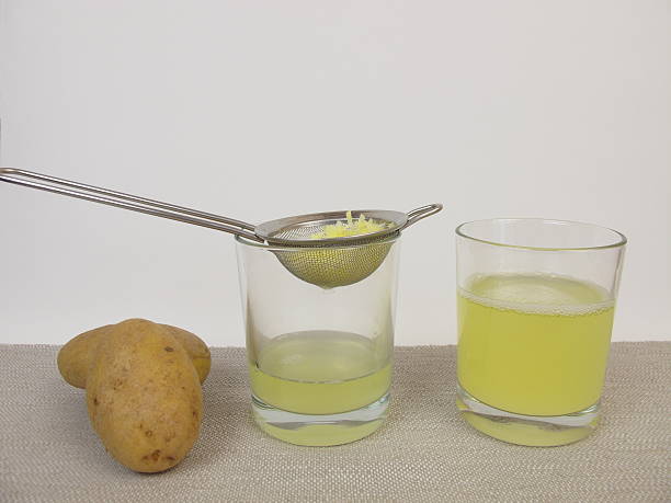 Freshly pressed raw potato juice stock photo