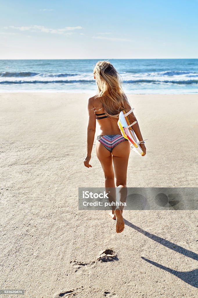 Summertime. Surfing. Summer Sport. Woman With Surfboard Running Summertime. Surfing. Summer Leisure Sport Activity. Beautiful Sporty Young Woman With Sexy Body In Bikini With Surf Board Running On Beach. Extreme Water Sports. Healthy Lifestyle. Holiday Vacations. Extreme Sports Stock Photo