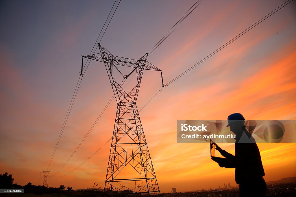 Electrical engineer while working laptopl Electrical engineer while working laptopl. Power Line Stock Photo Electrical engineer while working laptopl Electrical engineer while working laptopl. Power Line Stock Photo