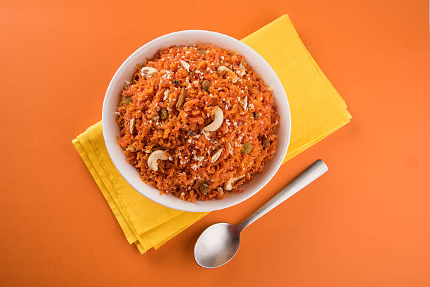 Gajar halwa or carrot halwa, indian sweet Gajar halwa or carrot halwa, famous indian dessert made using carrot sugar and milk and toppings of almond cachew nuts and pistachios, Carrot halwa - Diwali sweet made of carrots milk and sugar, favourite dish in parties, weddings in india india sweets stock pictures, royalty-free photos & images