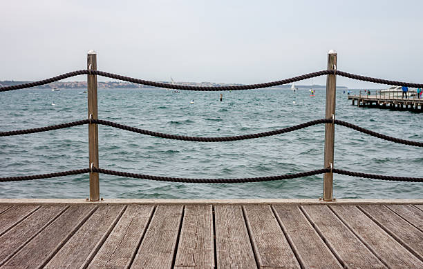 istock Empty wooden seafront with fence 522626294