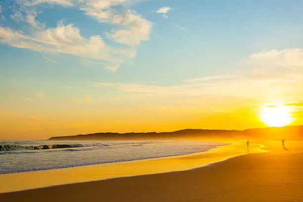 Photo of Two people on the beach at sunset, Australia