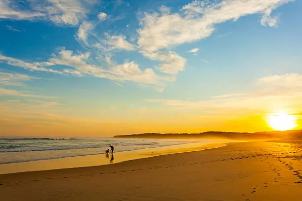 Photo of Two people on the beach at sunset, Australia
