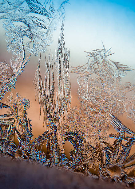 ice pattern Frosty pattern in daylight obtained at low temperature on the window glass. icicle snowflake winter brilliant stock pictures, royalty-free photos & images