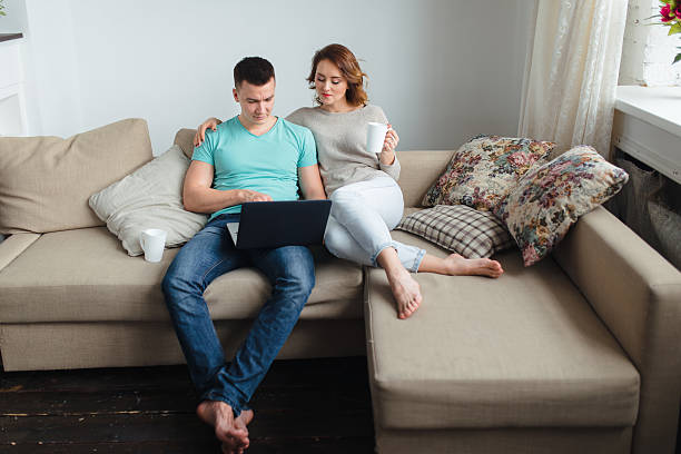 Free Stock Photo of Three People Sitting on a Couch Looking at a Laptop ...