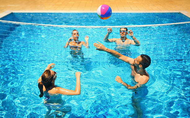 istock Friends playing volleyball in a pool. 522631632