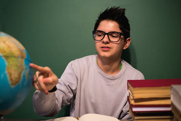 istock Closeup of little boy learning about the world using globe 522631750