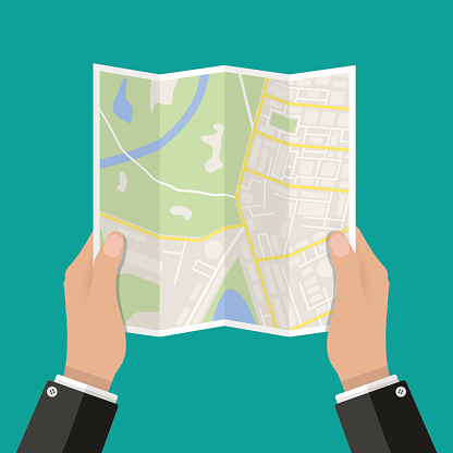 Folded Paper Map In Hand, Abstract generic city map with roads, buildings, parks, river. Vector Illustration in flat design on green background
