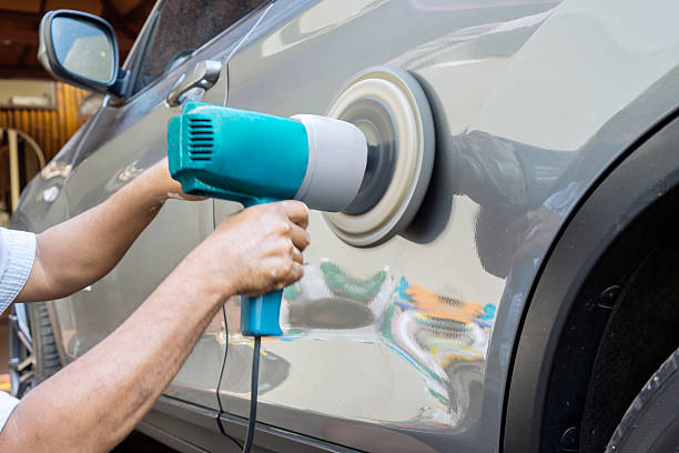 istock Hands polish a car body with polisher 522634828