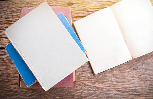 istock Open book on wooden backgroundOpen book on wooden background 522635468