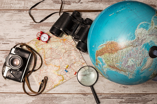 travel picture set with camera, binocular,globe, magnifying glass on map