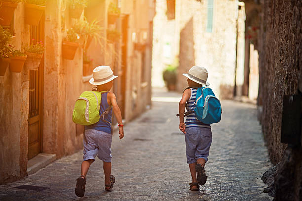 istock Kids running in mediterranean street. 522636104