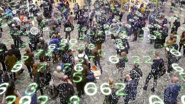 Mobile devices emitting data in a crowd of people. stock photo