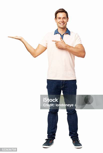 Confident Man Pointing At Invisible Product Stock Photo - Download Image Now - Arms Outstretched, Standing, Full Length