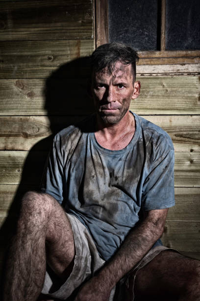 Filthy Manual Worker Candid shot of a filthy manual worker (might be a coal miner). Might be a down and out. Might be a model posing. miners cabin stock pictures, royalty-free photos & images