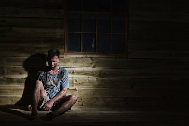 Filthy Manual Worker After His Shift Candid shot of a filthy manual worker (might be a coal miner). Might be a down and out. Might be a model posing. miners cabin stock pictures, royalty-free photos & images