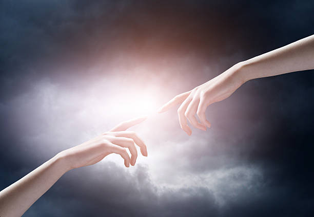 istock religion concept. finger touching the magic sky 522637552