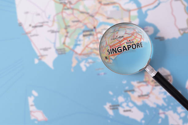 Consultation with magnifying glass map of Singapore Map of Singapore consulted with a magnifying glass highlighting the name of the city singapore map stock pictures, royalty-free photos & images