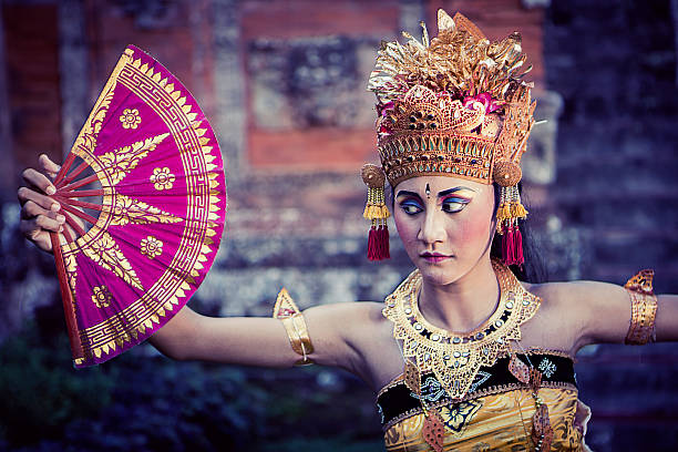 istock Vintage Bali performing dancer in a temple with fan 522638776