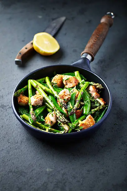 Stir-fried green asparagus, sugar snap peas and chicken breast