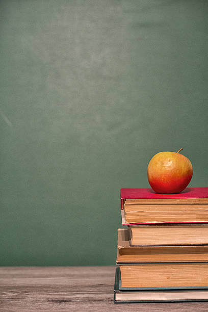 istock Apple on a pile of books. 522639342