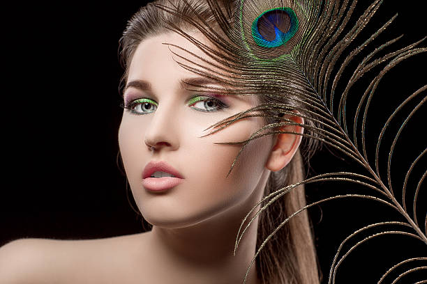 istock girl with bright  makeup and peacock feathe 522639582