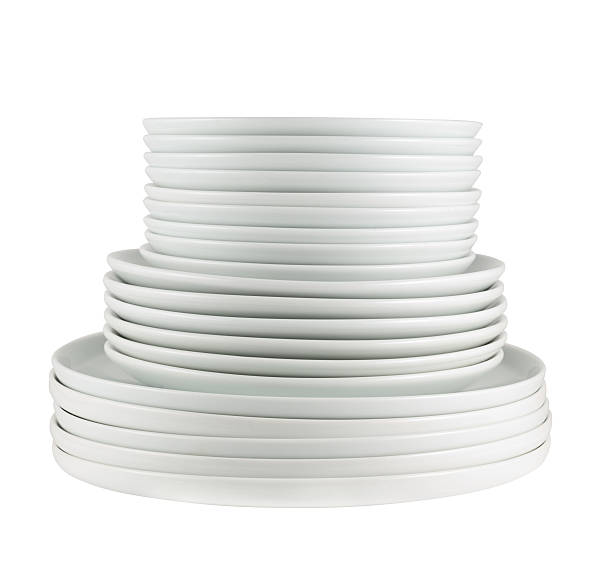 istock Pile of clean white dish plates isolated 522640108