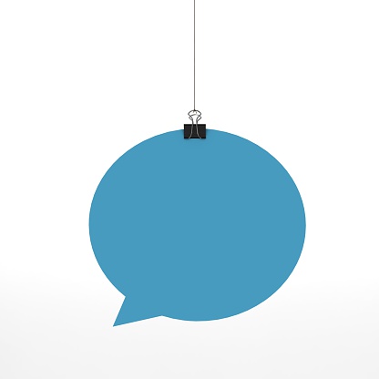 A  3D representation of a speech bubble hanging on a plain white background. The speech bubble is hanging from a binder paper clip that is attached to a piece of string.