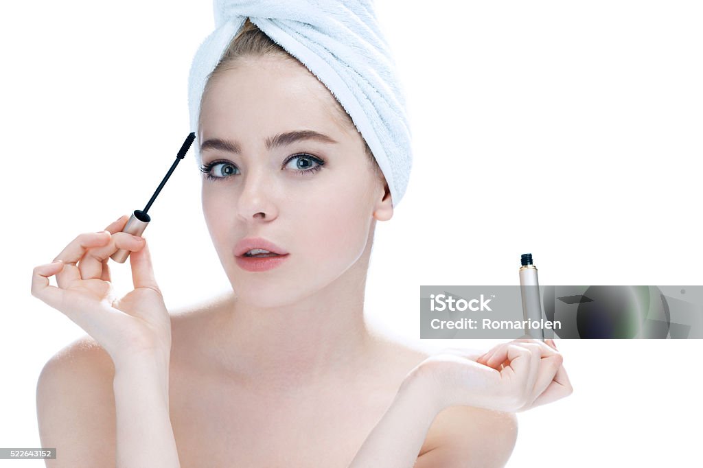 Woman applying black mascara Woman applying black mascara on eyelashes with makeup brush / photos of appealing girl on white background Fashion Model Stock Photo