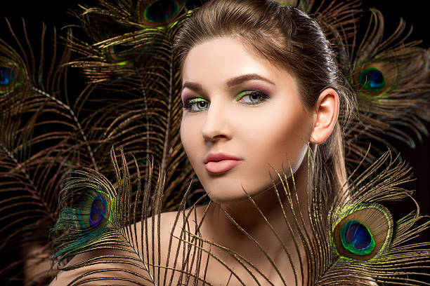 istock girl with bright  makeup and peacock feathe 522643746