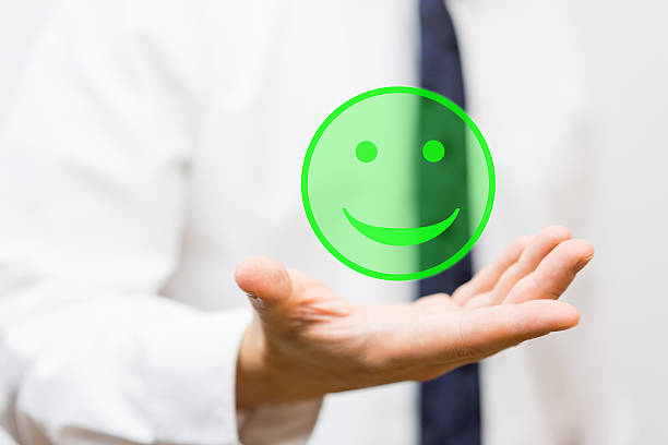 istock businessman is holding virtual smiley in his hand, 522643974