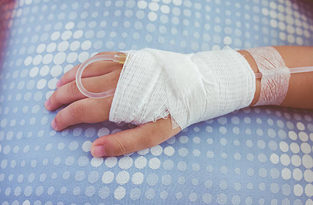 istock Saline intravenous (iv) drip in a child's patient hand. 522644056
