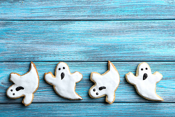 istock Fresh halloween gingerbread cookies on blue wooden table 522644334