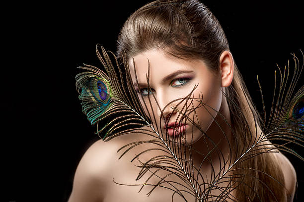 istock girl with bright  makeup and peacock feathe 522644432