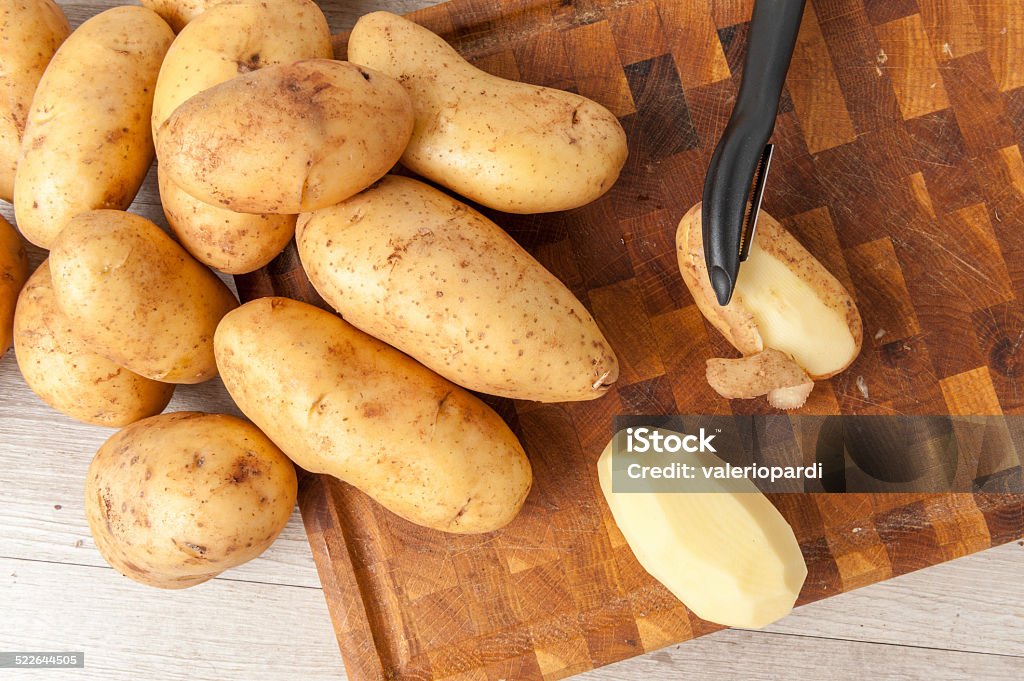 Potatoes potatoes ready to be peeled on a cutting board Agriculture Stock Photo