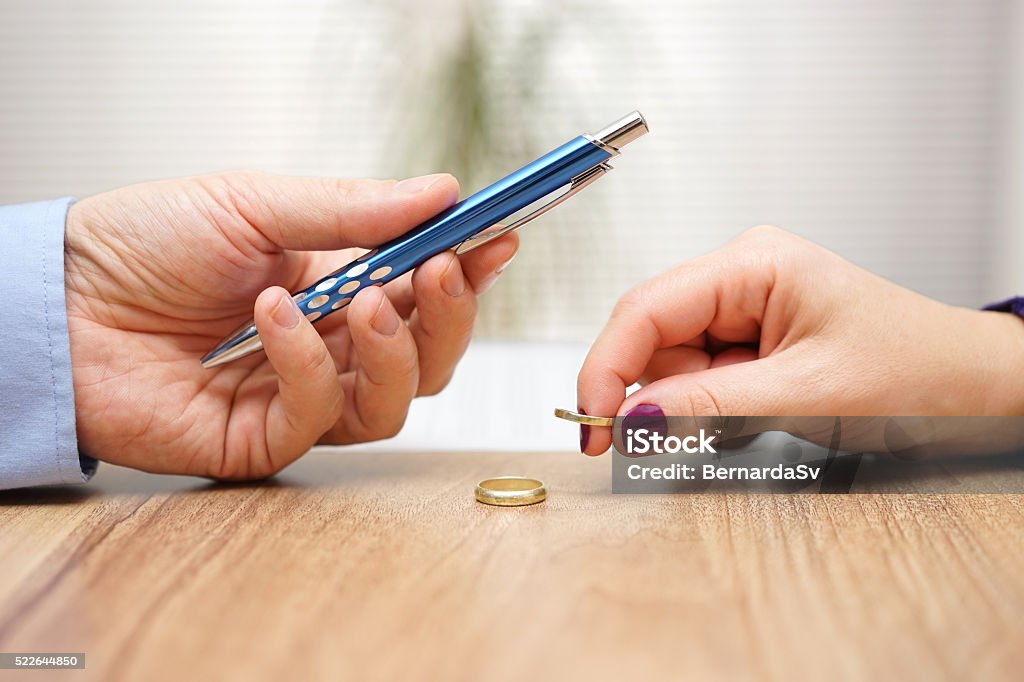 Mari donner un stylo à signer le divorce journaux sa femme - Photo de Divorce libre de droits