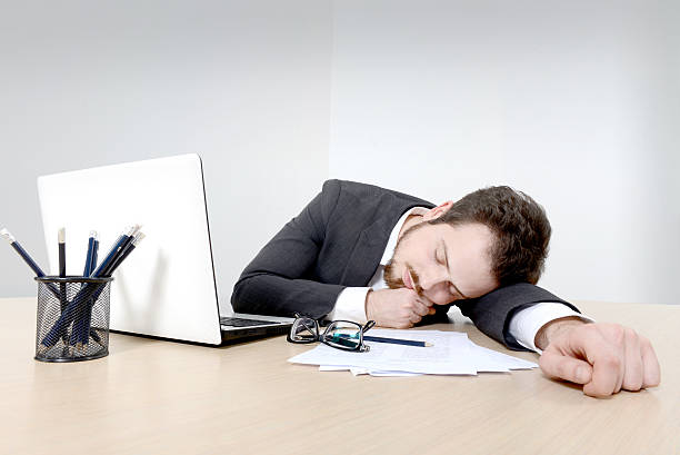 istock Young businessman sleeping on the office desk 522646653