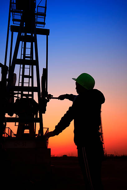 istock oil field, the oil workers are working 522647044