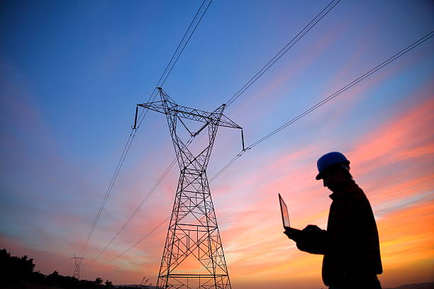 Electrical engineer while working laptopl stock photo