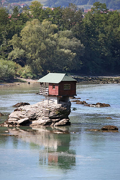 istock house on rock Drina river Serbia 522647676