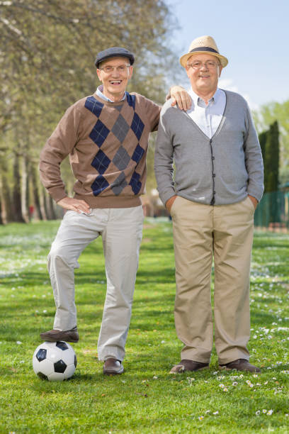 istock Two senior gentlemen posing with a football 522648536